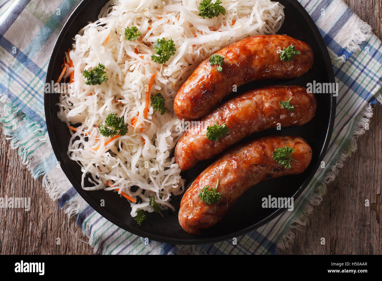 German bratwurst and sauerkraut on a plate on the table. Horizontal top