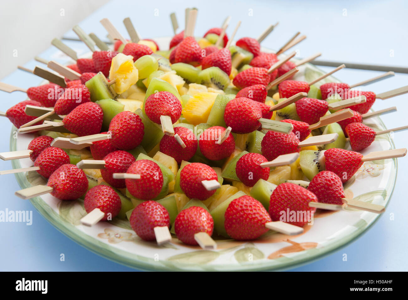 Strawberry, pineapple and kiwi fruit kebabs Stock Photo Alamy