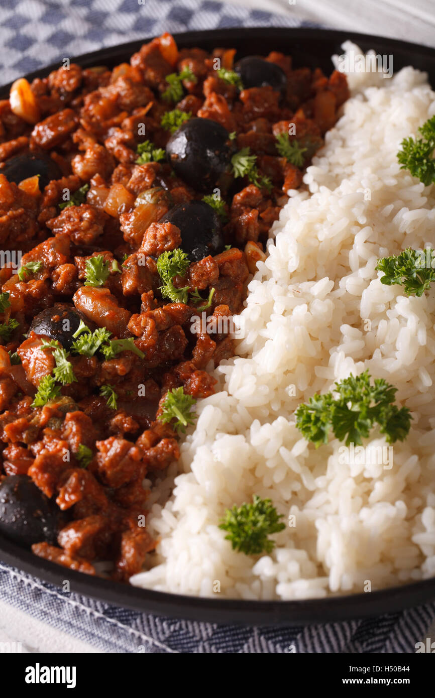 Latin American cuisine: Picadillo a la habanera with a side dish of rice macro. Vertical Stock Photo