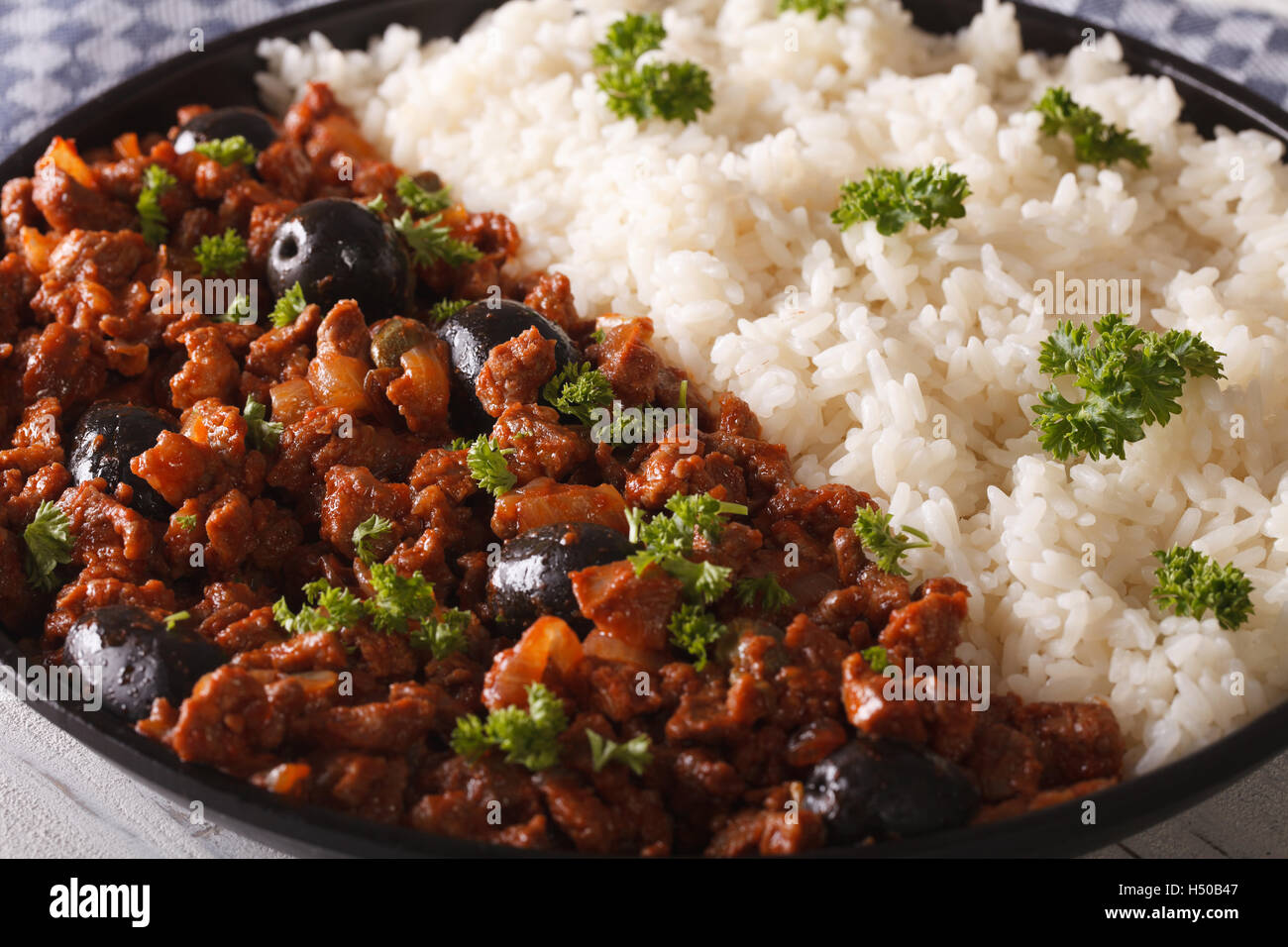 Latin American cuisine: Picadillo a la habanera with a side dish of rice macro. horizontal Stock Photo