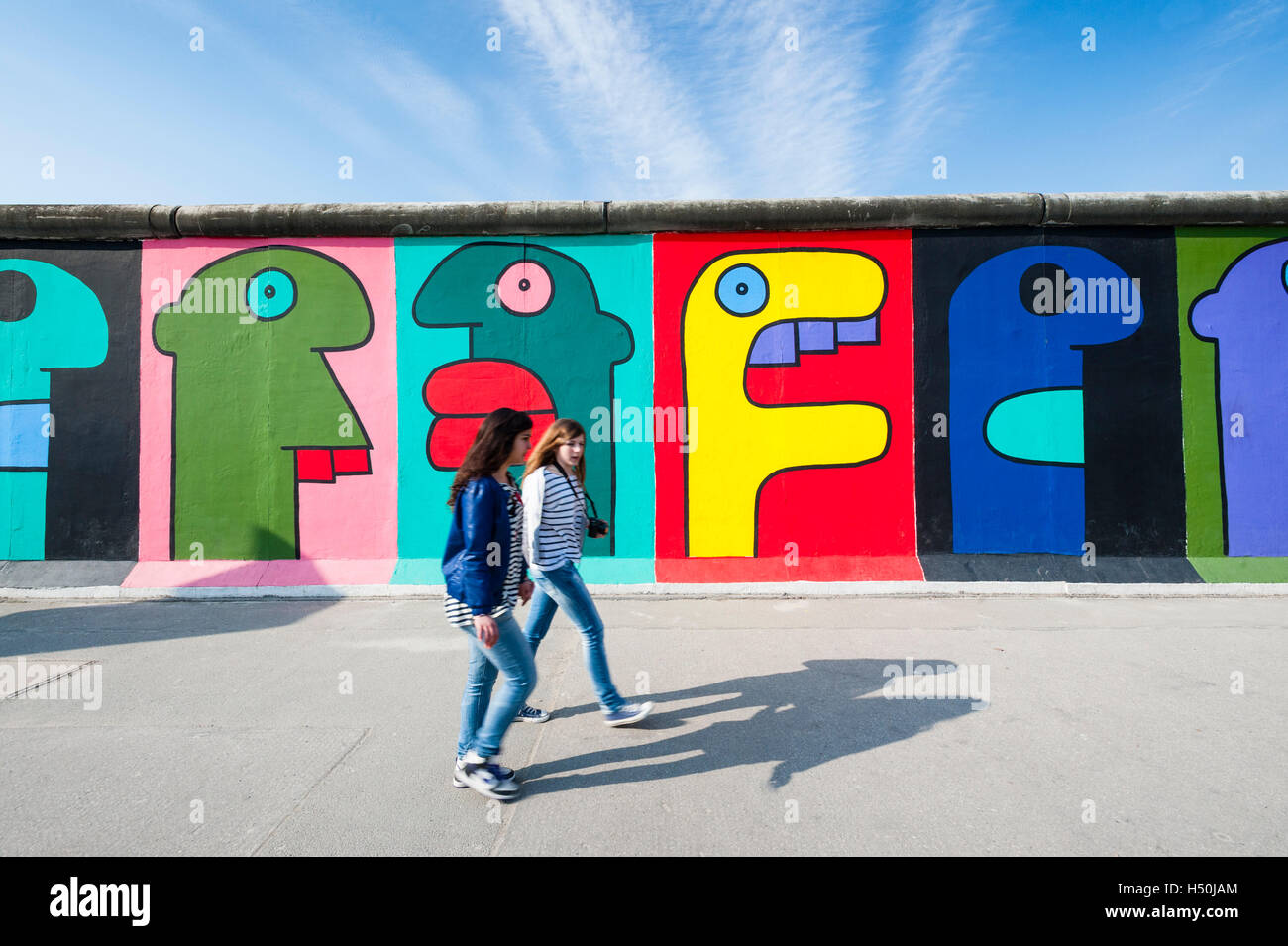 Colourful murals at East Side Gallery at former Berlin Wall in Friedrichshain/Kreuzberg in Berlin Germany Stock Photo