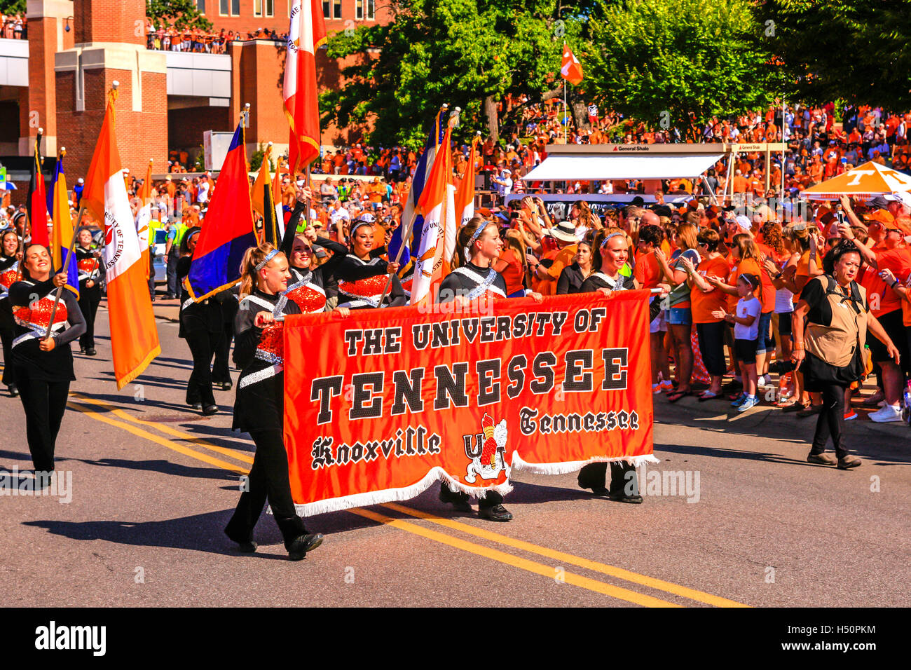 Cheerleaders from the University of Tennessee carry the banner into