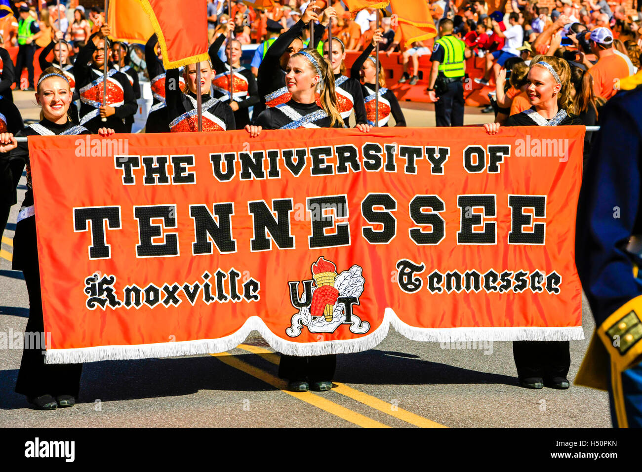 Cheerleaders from the University of Tennessee carry the banner into Neyland Stadium in Knoxville, TN Stock Photo