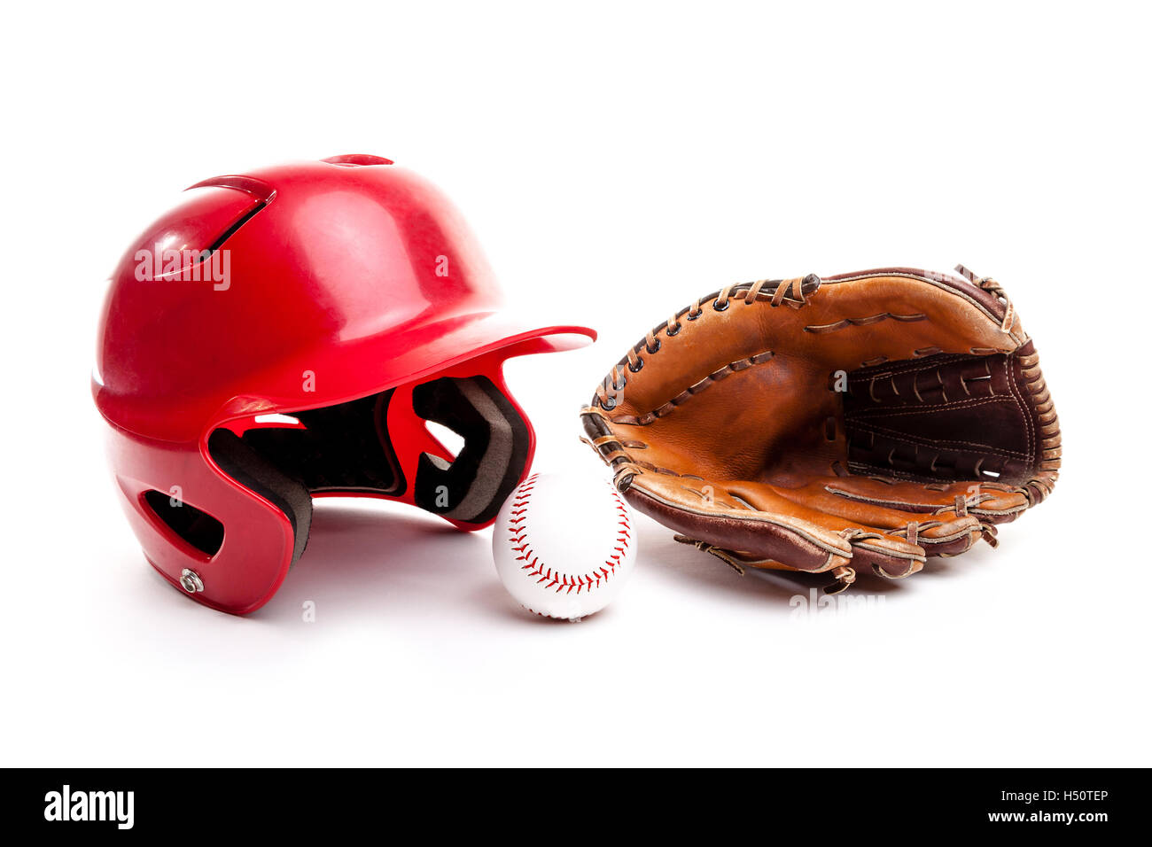 Baseball equipment consisting of red helmet, leather glove and baseball. Isolated on white background. Stock Photo