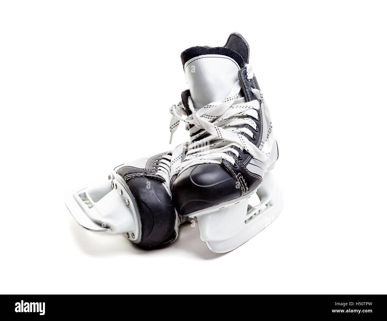 Close up on a pair of ice hockey skates with loose laces isolated on white background with copy space. Stock Photo