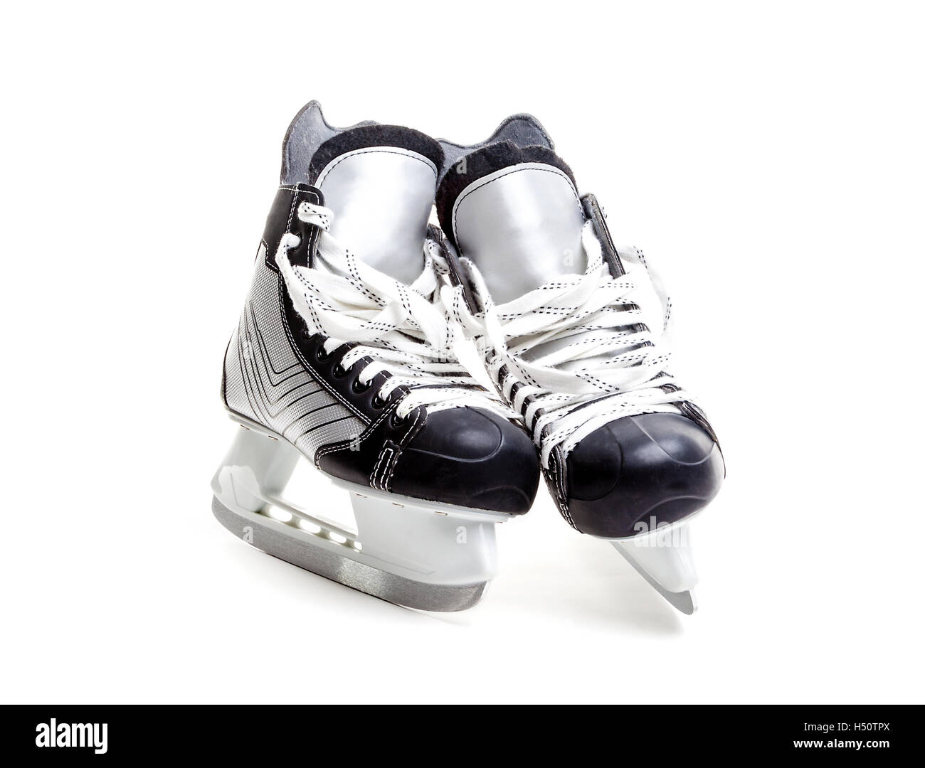 Close up on a pair of ice hockey skates with loose laces isolated on white background with copy space. Stock Photo