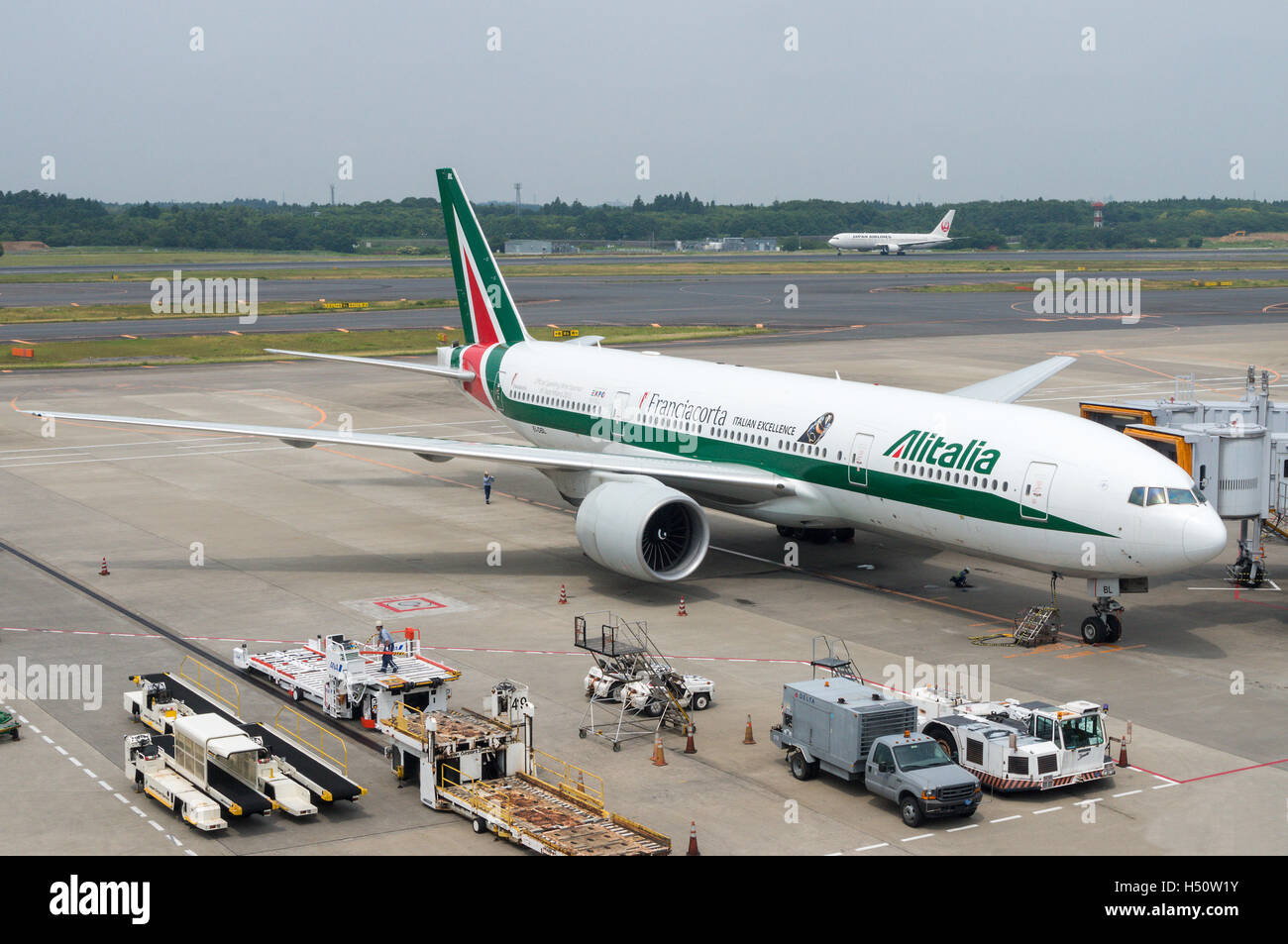 Tokyo, Japan - June 15, 2015: An Alitalia plane being serviced on the tarmac of Tokyo Narita Airport. An Italy flagship, Alitali Stock Photo