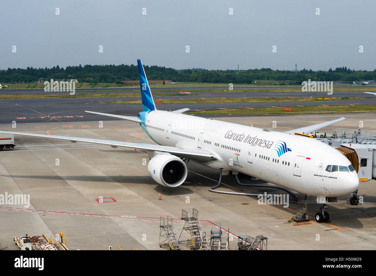 Tokyo, Japan - June 15, 2015: A Garuda Indonesia plane being serviced on the tarmac of Tokyo Narita Airport. Stock Photo