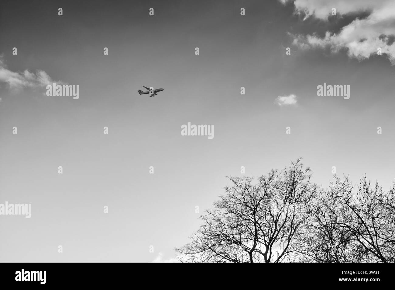 Airplane flying in sky over Black and White Stock Photos & Images - Alamy