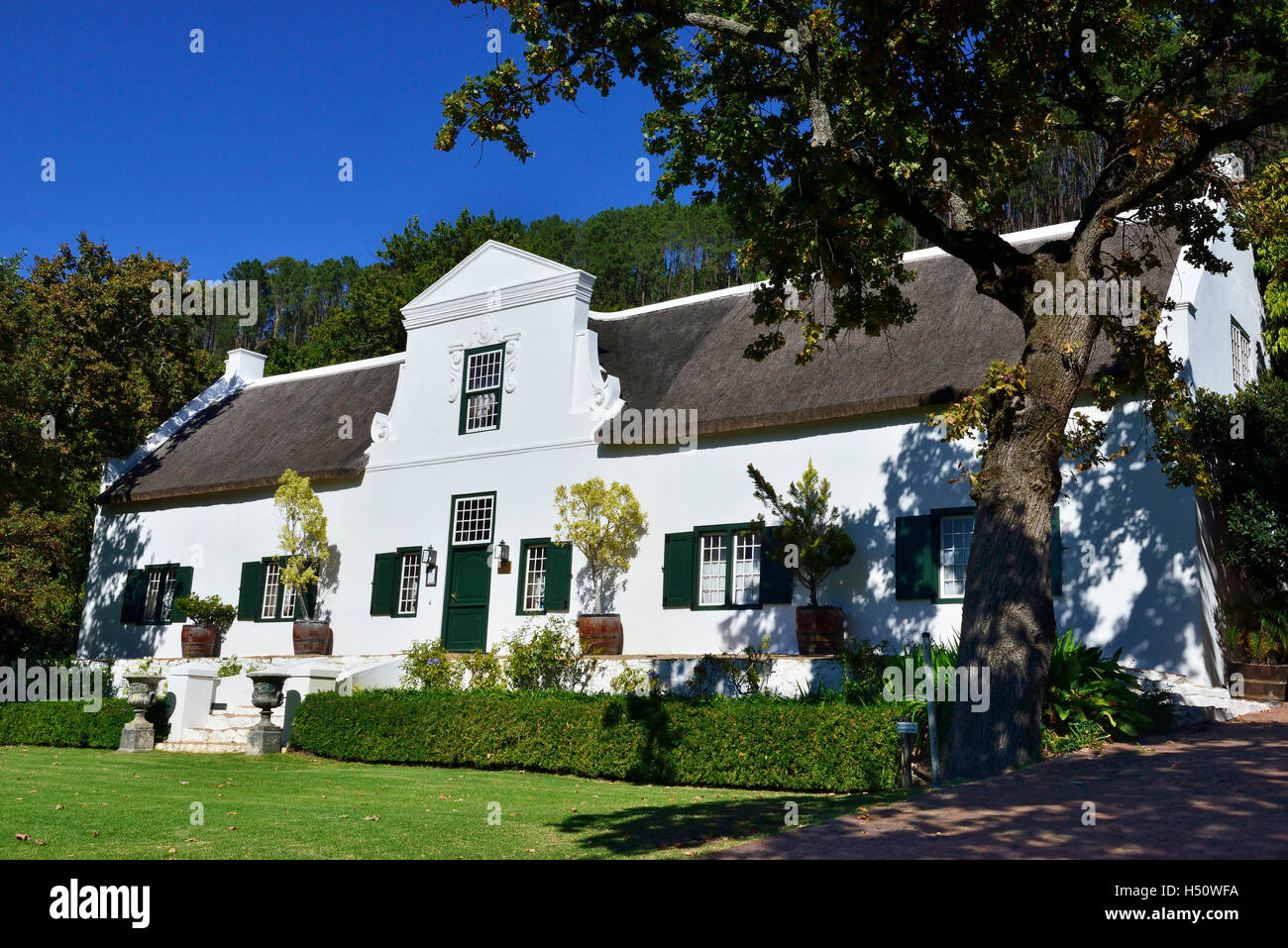 Dutch style gabled mansion at the Rickety Bridge Winery, Franschhoek,  Western Cape , South Africa Stock Photo