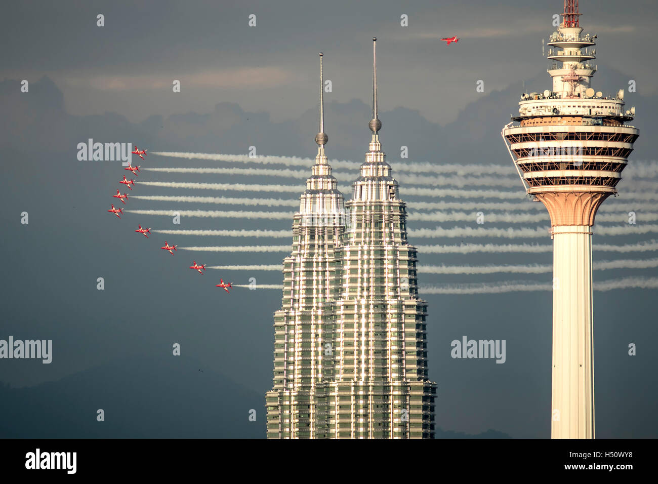 Kuala Lumpur, Malaysia. 18th Oct, 2016. British RAF Red Arrows in formation, flying past KLCC Twin Towers and KL Tower in view. Credit:  Danny Chan/Alamy Live News. Stock Photo