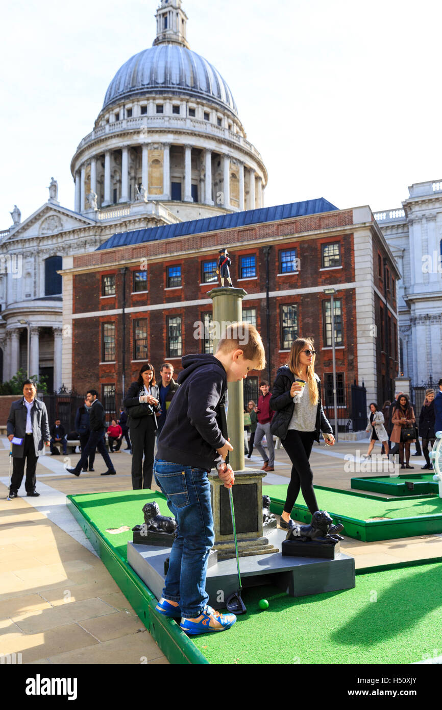 Paternoster Square, City of London, UK, 18th Oct 2016. City workers and visitors enjoy a round of crazy golf on Paternoster Square near St Paul's Cathedral in the City of London. The event is free for all to play and remains at Paternoster Square from 18th Oct to 21st Oct with competitions and a play off cup. The course includes a miniature Tower Bridge, London Eye and other iconic buiildings Credit:  Imageplotter News and Sports/Alamy Live News Stock Photo