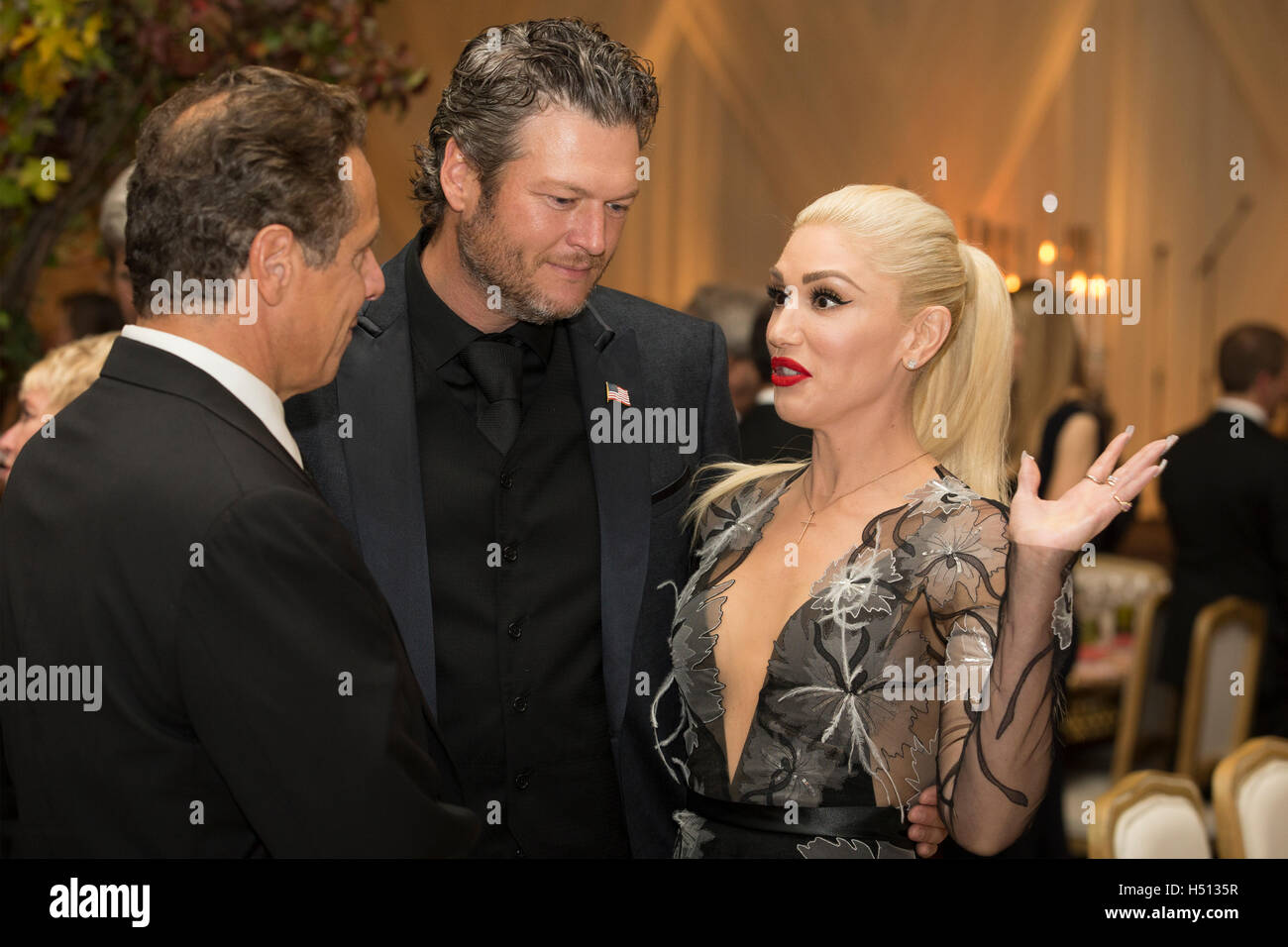 US entertainer Gwen Stefani (R), US entertainer Blake Shelton (C) and New York Governor Andrew Cuomo (L) attend a state dinner for Italian Prime Minister Matteo Renzi, hosted by US President Barack Obama, on the South Lawn of the White House in Washington DC, USA, 18 October 2016. President Obama hosts his final state dinner, featuring celebrity chef Mario Batali and singer Gwen Stefani performing after dinner. Credit: Michael Reynolds/Pool via CNP/MediaPunch Stock Photo