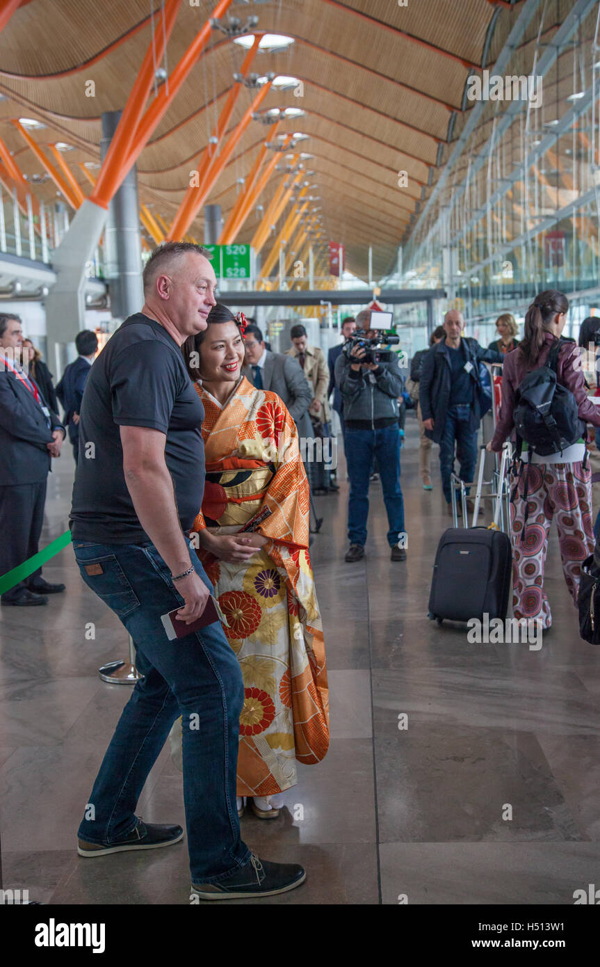 Japanese girl dressed in traditional kimono welcoming and photographing with passengers and media boarding the first inaugural direct Iberia flight between Spain and Japan (IB6801 Madrid, Barajas to Tokyo, Narita on 18 October 2016) Stock Photo