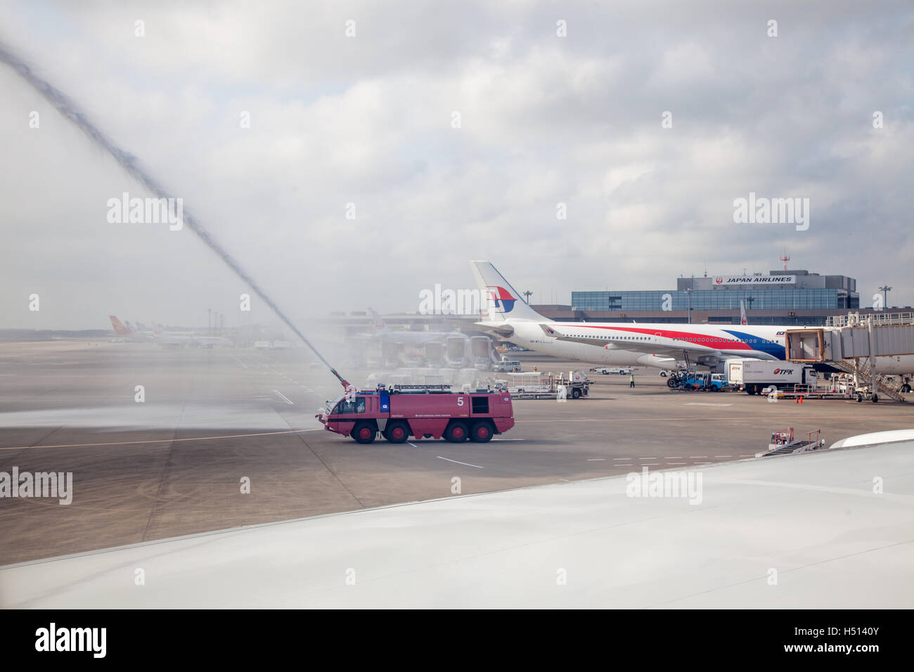 Water cannon salute welcoming just landed Iberia airlines aircraft flying inaugural flight IB6801 from Madrid, Spain arriving to Narita International airport, Tokyo, Japan on 19 October 2016  Credit:  ImageNature, Alexander Belokurov / Alamy Stock Photo