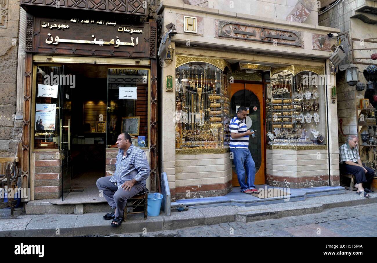 Cairo, Egypt. 13th Oct, 2016. Egyptian vendors stand outside their jewellery store, in cairo