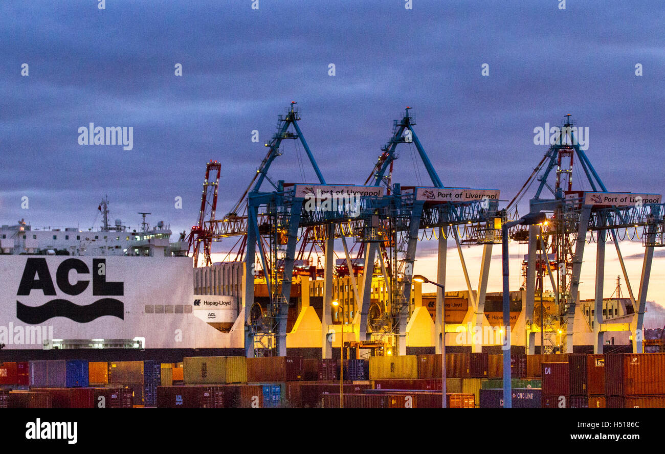 Operational cantilever rail-mounted gantry (CRMG) cranes Liverpool, Merseyside, UK. 19th October, 2016.  The new Atlantic Container Line (ACL) vessel Atlantic Sea arrives in Seaforth where dock cranes are undertaking loading and unloading at dusk.  The ship is one of five new vessels that will double ACL’s capacity to carry shipping containers from the UK and Europe across the Atlantic. The Container Roll-On/Roll-Off ships are the world’s largest and most advanced vessels of their kind. Stock Photo