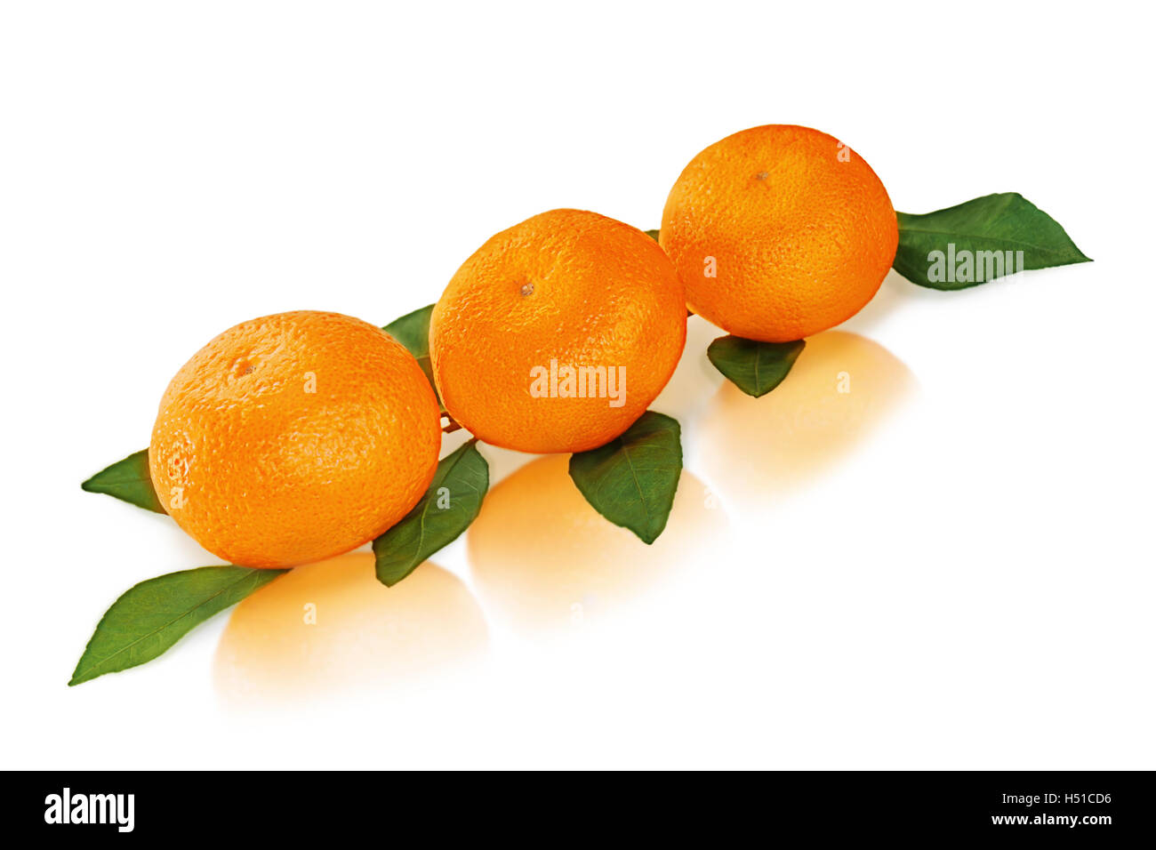 Fresh tangerines with green leaves isolated on white background. Stock Photo