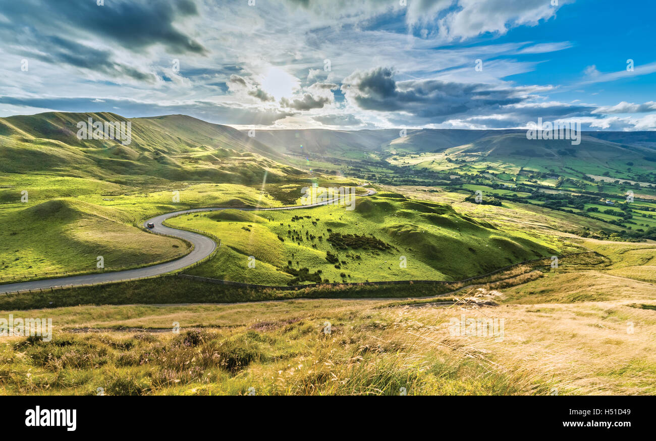 Serpentine Road Among Green Hills of Peak District National Park Stock Photo