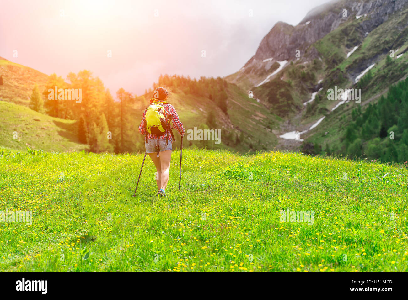 Girl hiking on mountain trail in summer Stock Photo Alamy