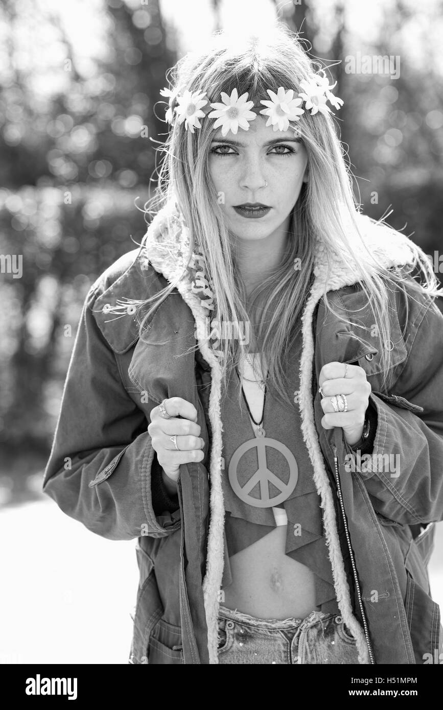 Girl hippie revolutionary in 1970 style  with the symbol of peace and eskimo. Picture ruined simulation Stock Photo