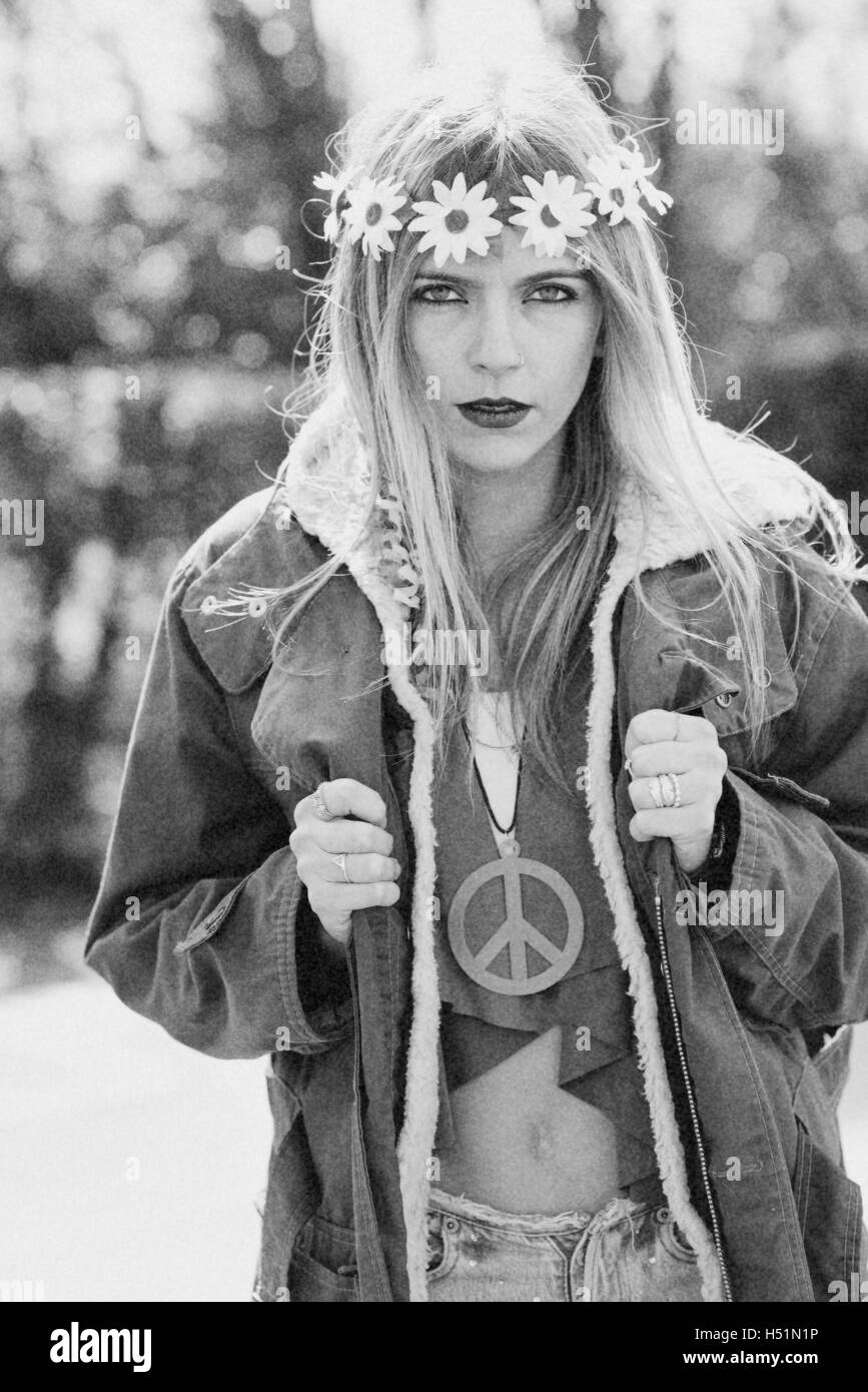 Girl hippie revolutionary in 1970 style  with the symbol of peace and eskimo Stock Photo
