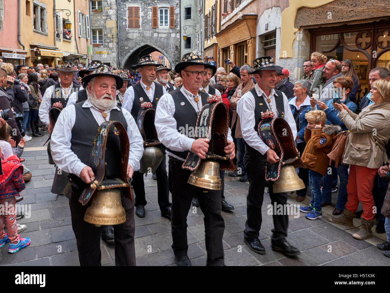 Men ringing cowbells during the Retour des Alpages festival. Annecy, Haute-Savoie, France. Stock Photo