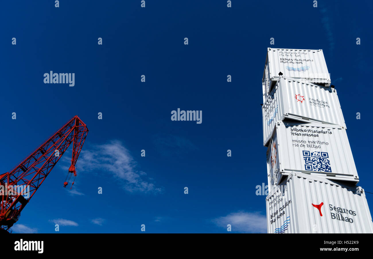 LA CAROLA Crane decorates the old shipyards area of Bilbao along with a sculpture made from old shipping containers Stock Photo