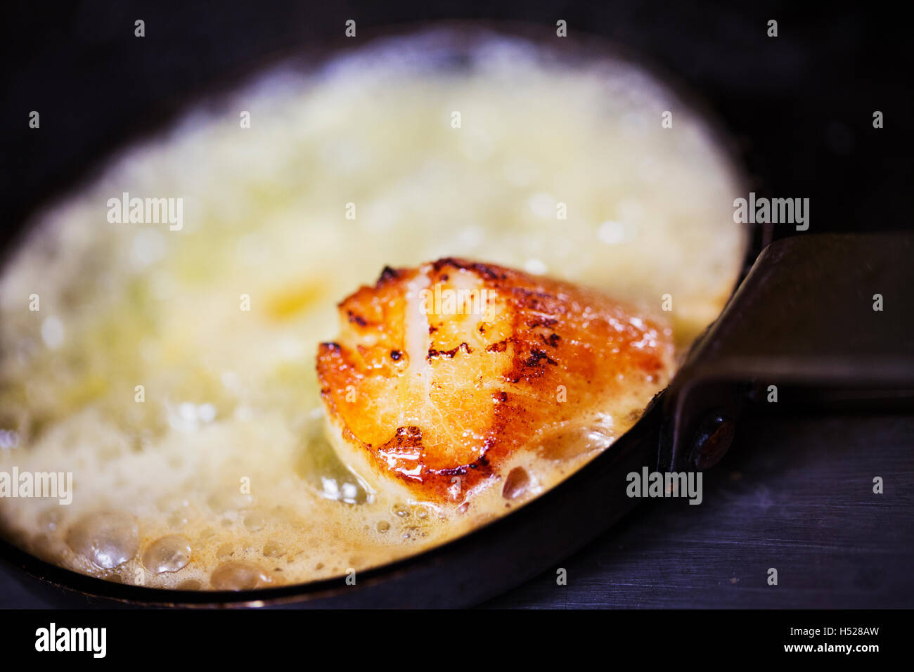 Close up of a scallop in a frying pan. Stock Photo