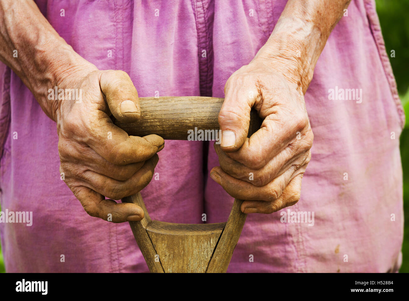 A woman holding a shovel on a farm Stock Photo - Alamy