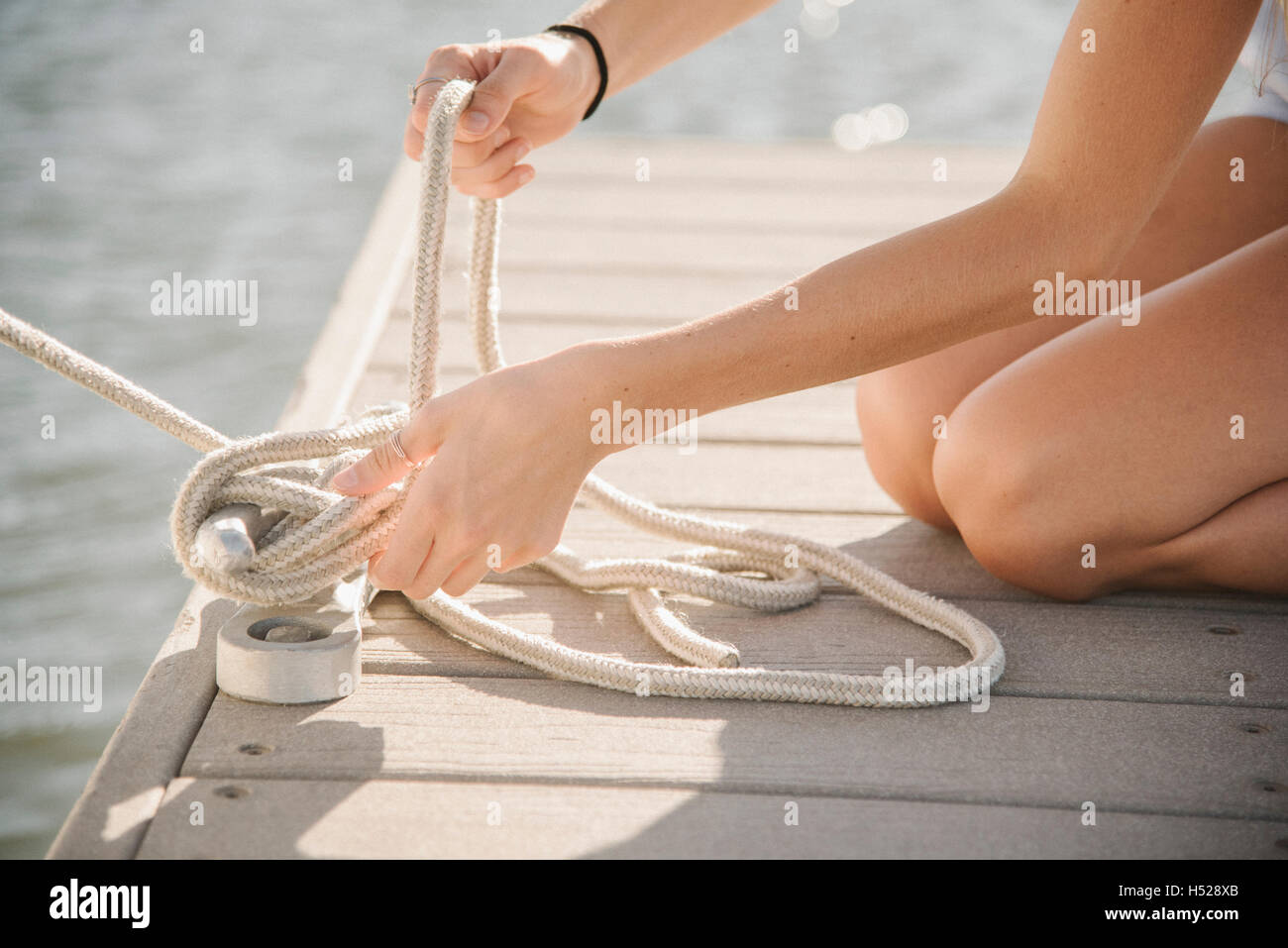 Woman tying rope hi-res stock photography and images - Alamy