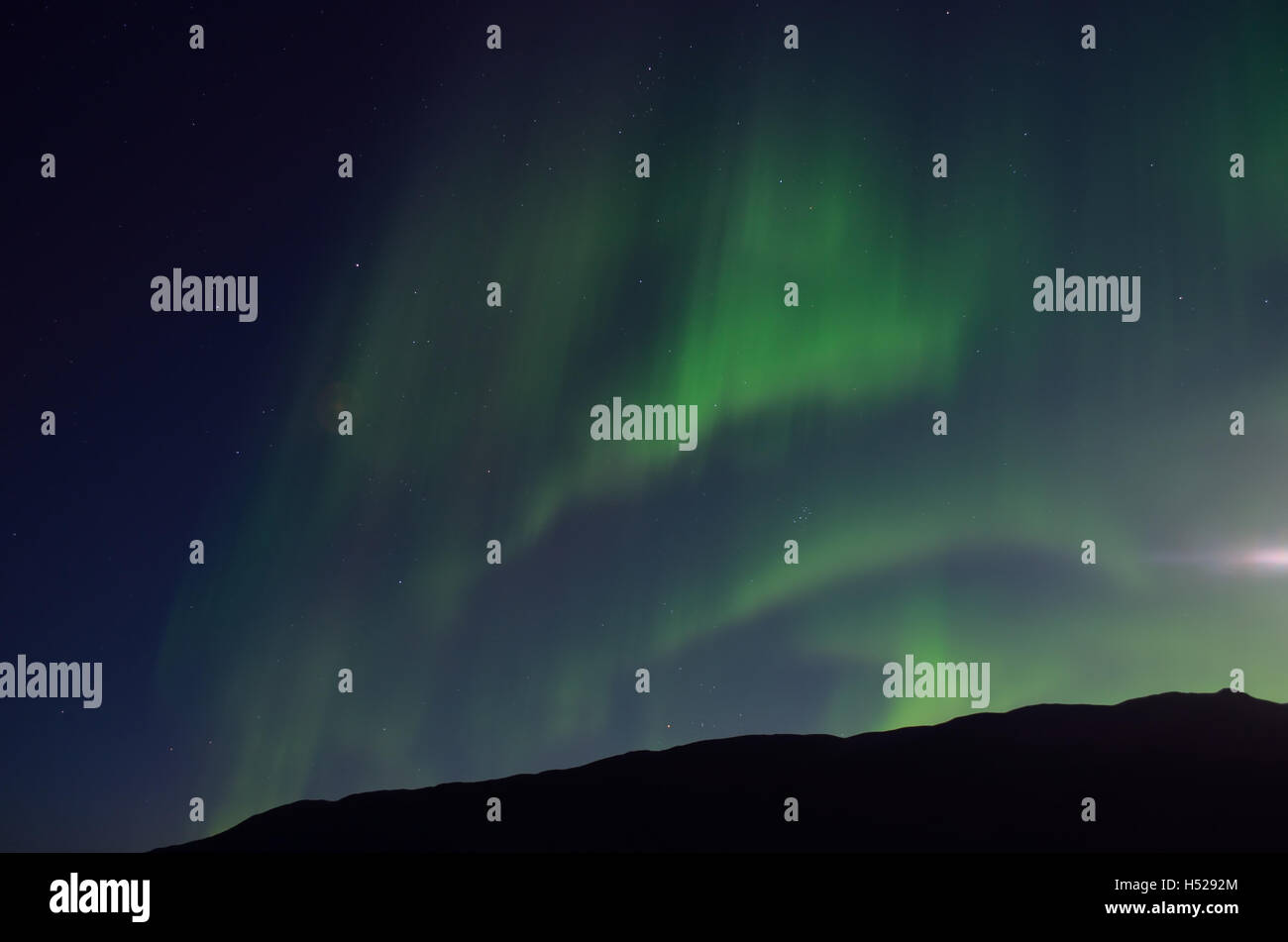 massive aurora borealis dancing on night sky over mountain in northern ...