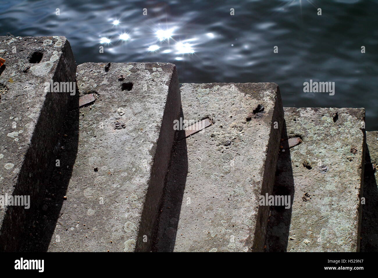 Old concrete stairway steps on waterside with lightspots. Stock Photo