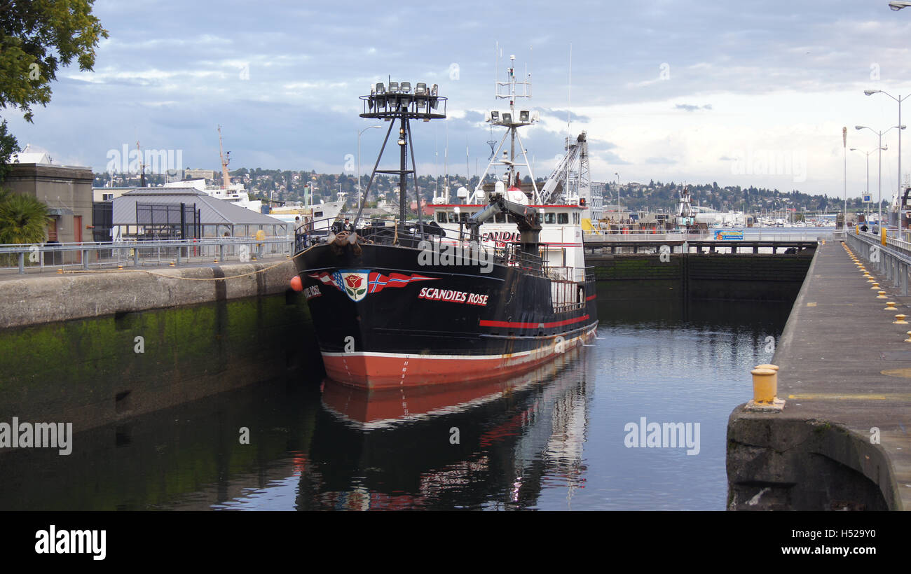SEATTLE, WASHINGTON STATE, USA - OCTOBER 10, 2014: Hiram M. Chittenden Locks with large commercial fishing vessel docked in a ship canal Stock Photo