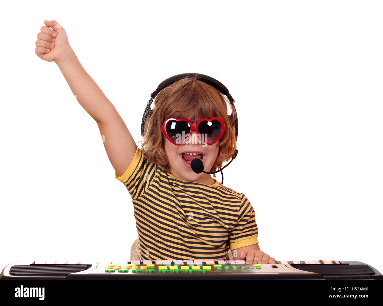 happy little girl play keyboard and sing Stock Photo