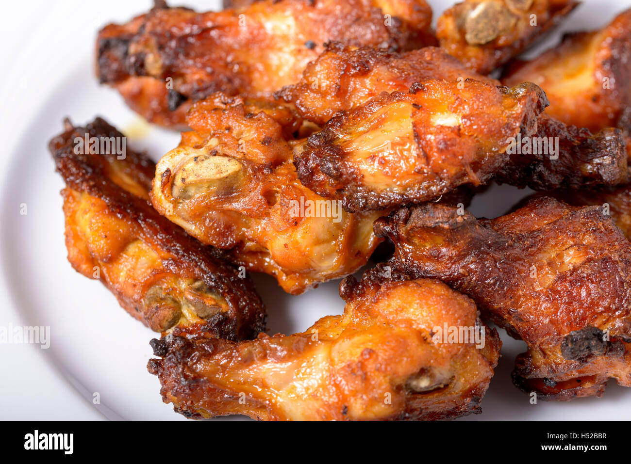 dish of spicy chicken wings on wood Stock Photo Alamy