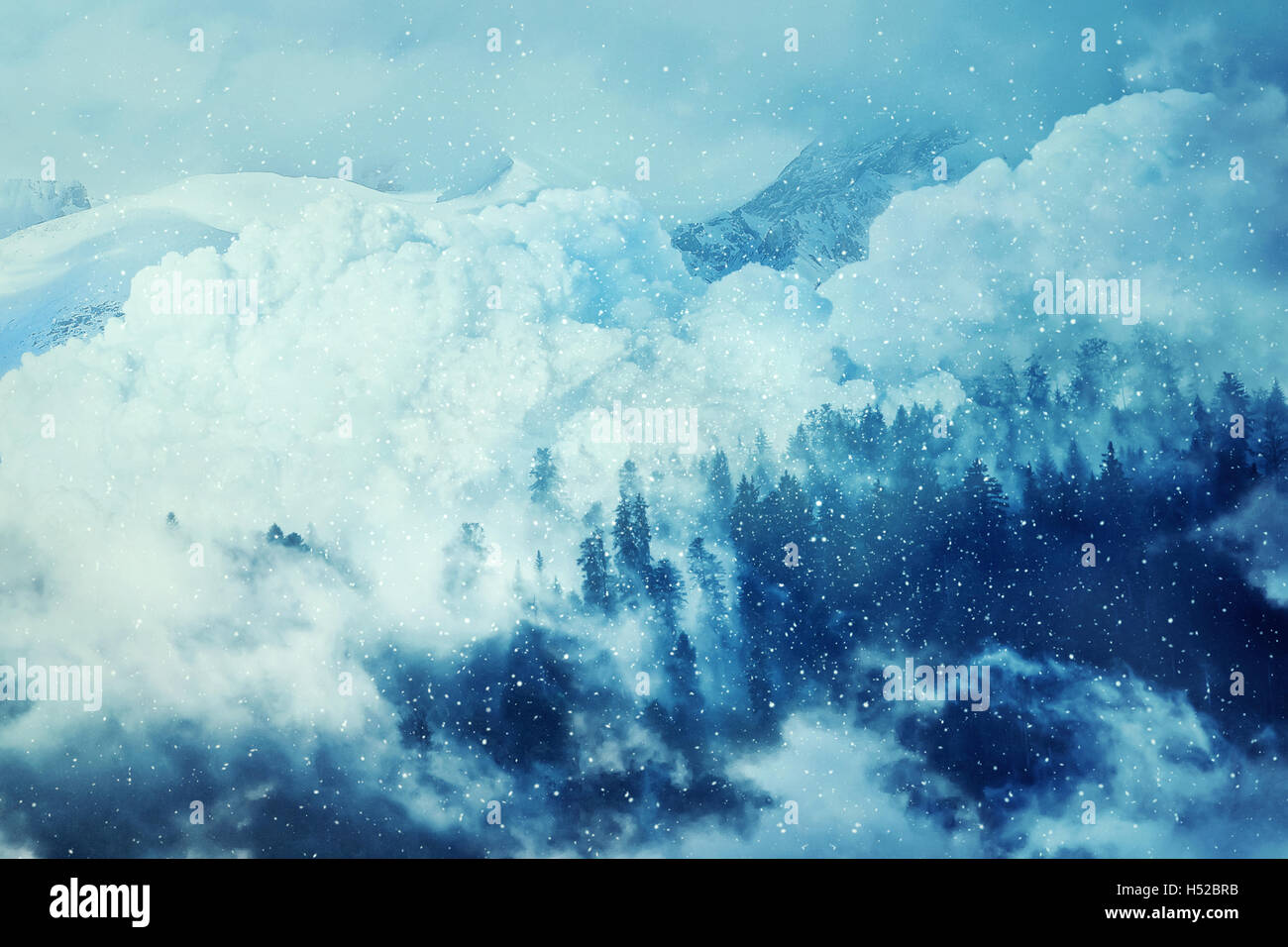 Fantastic winter background with an avalanche in the snowy mountains. Beautiful landscape mist and snowfall in the fir forest. T Stock Photo