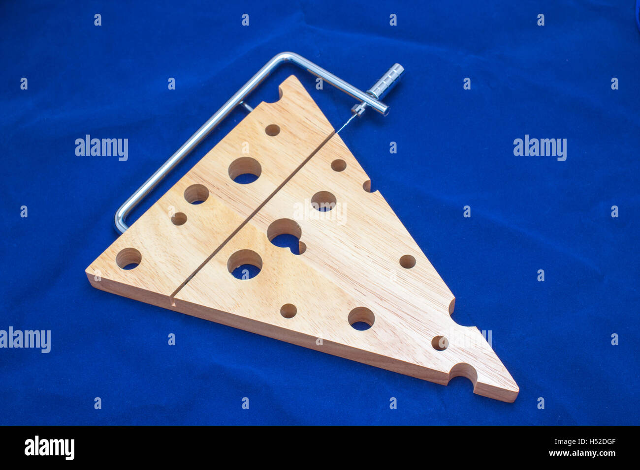Wooden chopping board with cheese cutter Stock Photo Alamy
