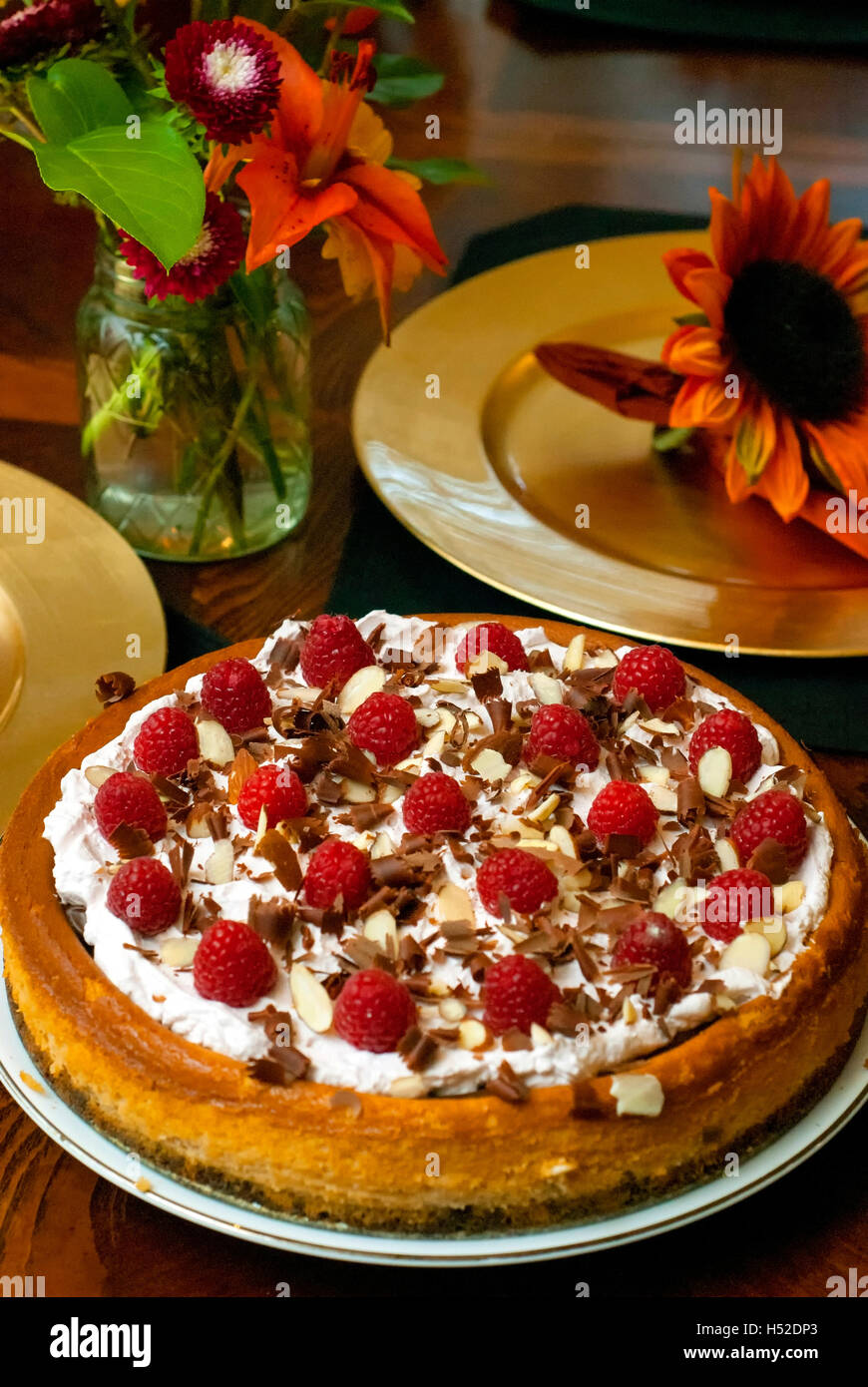 Raspberry chocolate cheesecake on a Fall table setting Stock Photo