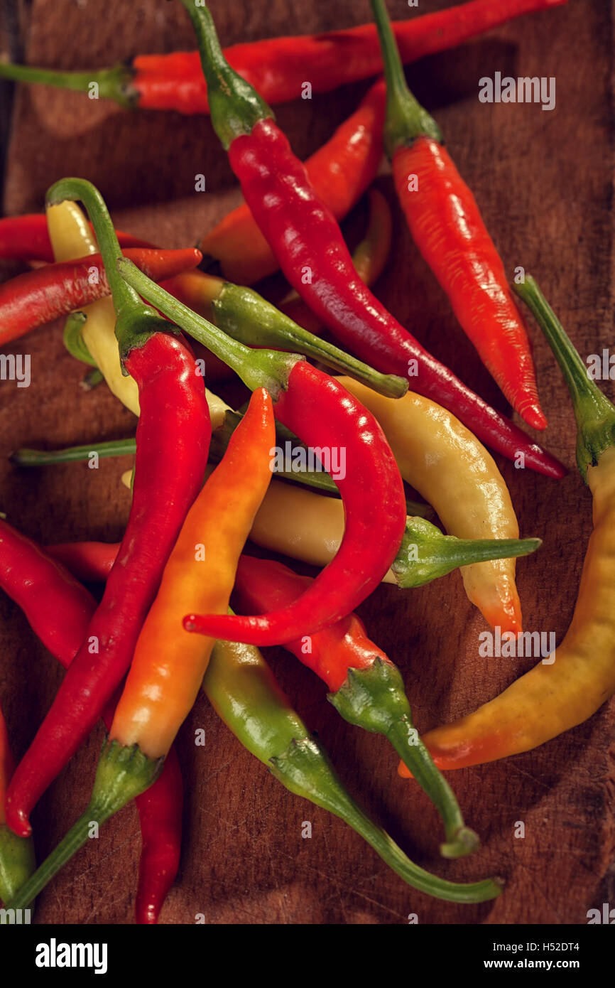Red Chili Peppers on wooden cutting board Stock Photo - Alamy