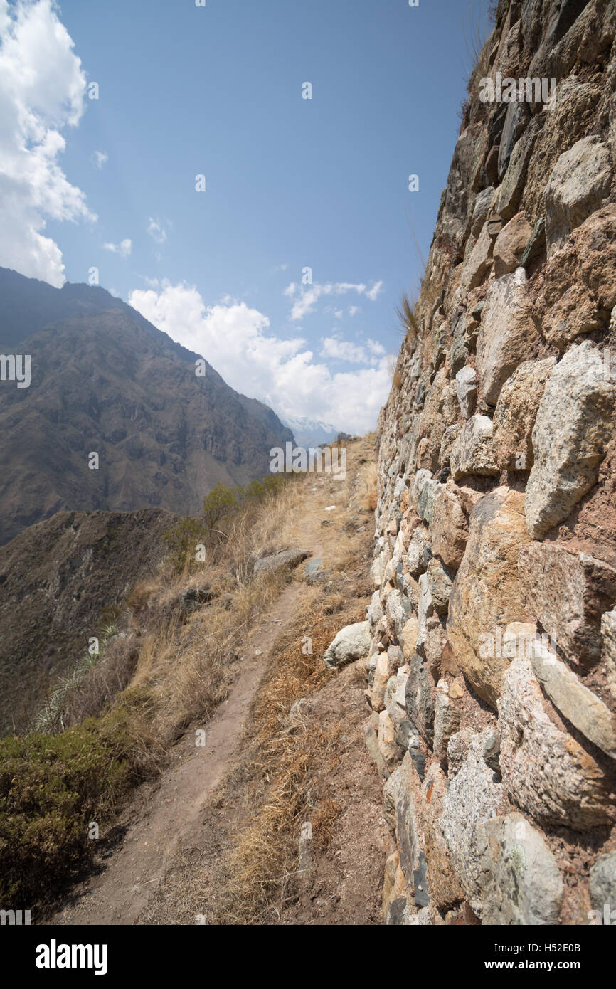 Close up to an Inca ruin wall along the edge of a mountain on the Inca Trail in the Sacred Valley of Peru Stock Photo