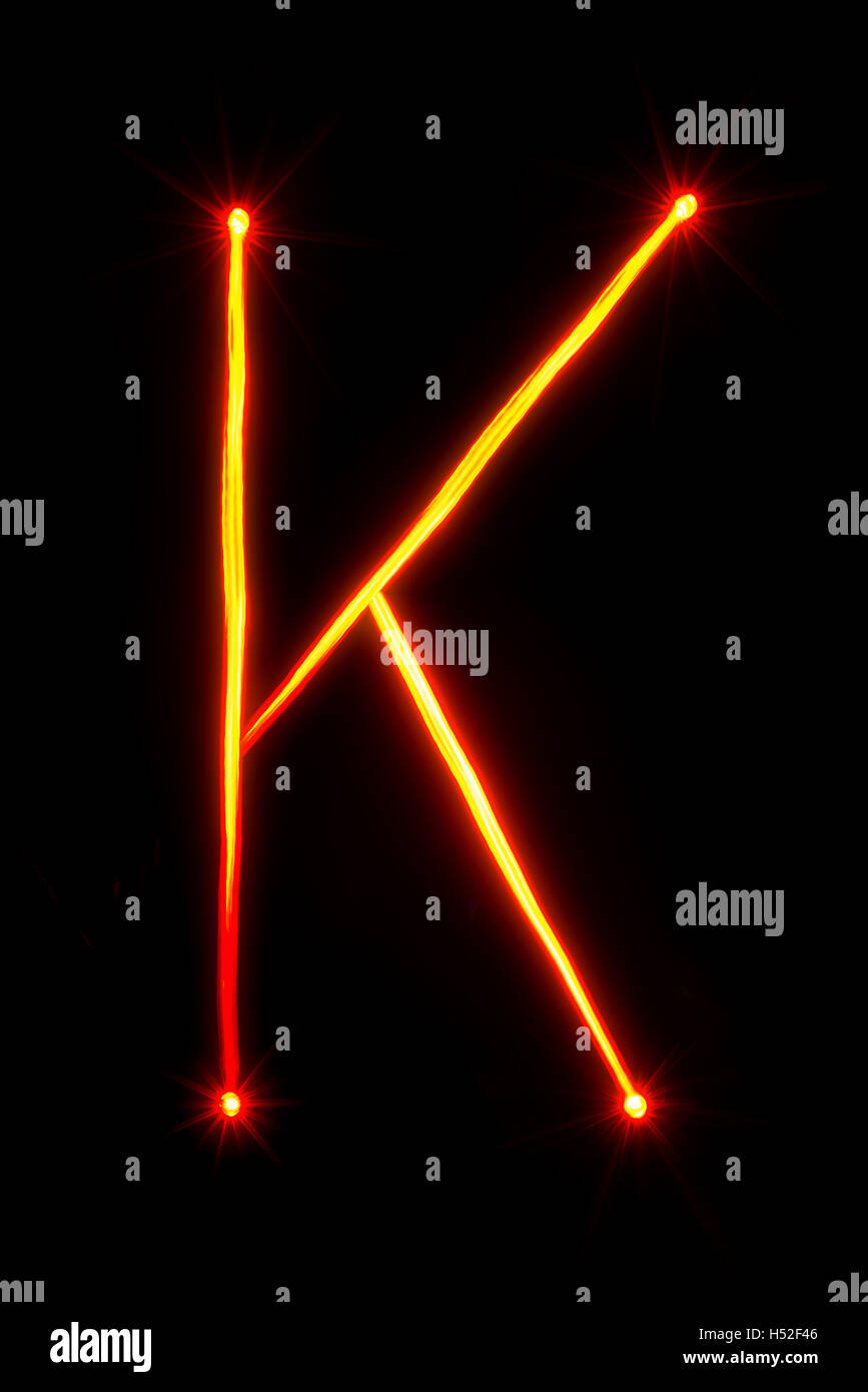 red thin light painting letter K on black background Stock Photo