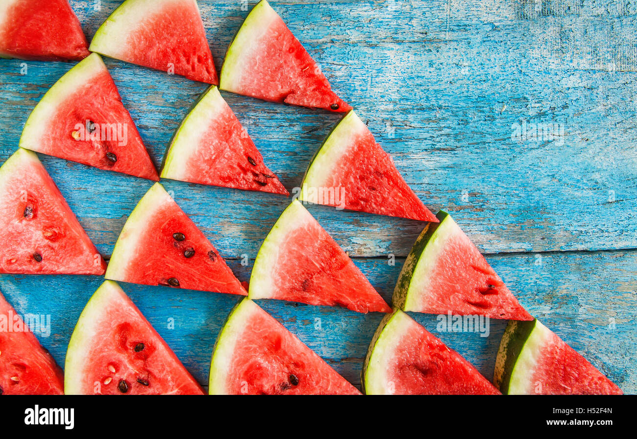 on a blue background flat triangles of watermelon Stock Photo - Alamy