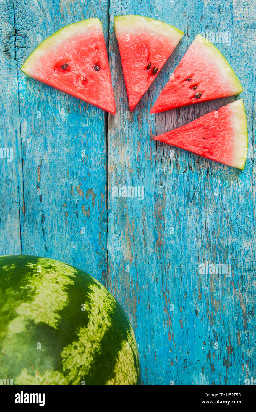 slice of watermelon on a blue background Stock Photo - Alamy