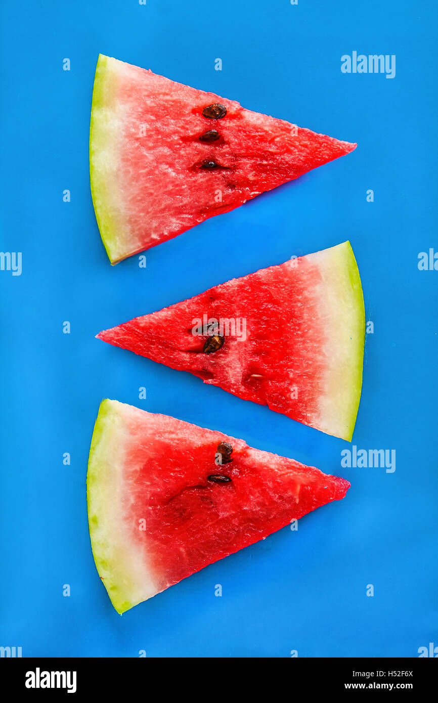 Tower of slices of watermelon on a blue background Stock Photo - Alamy