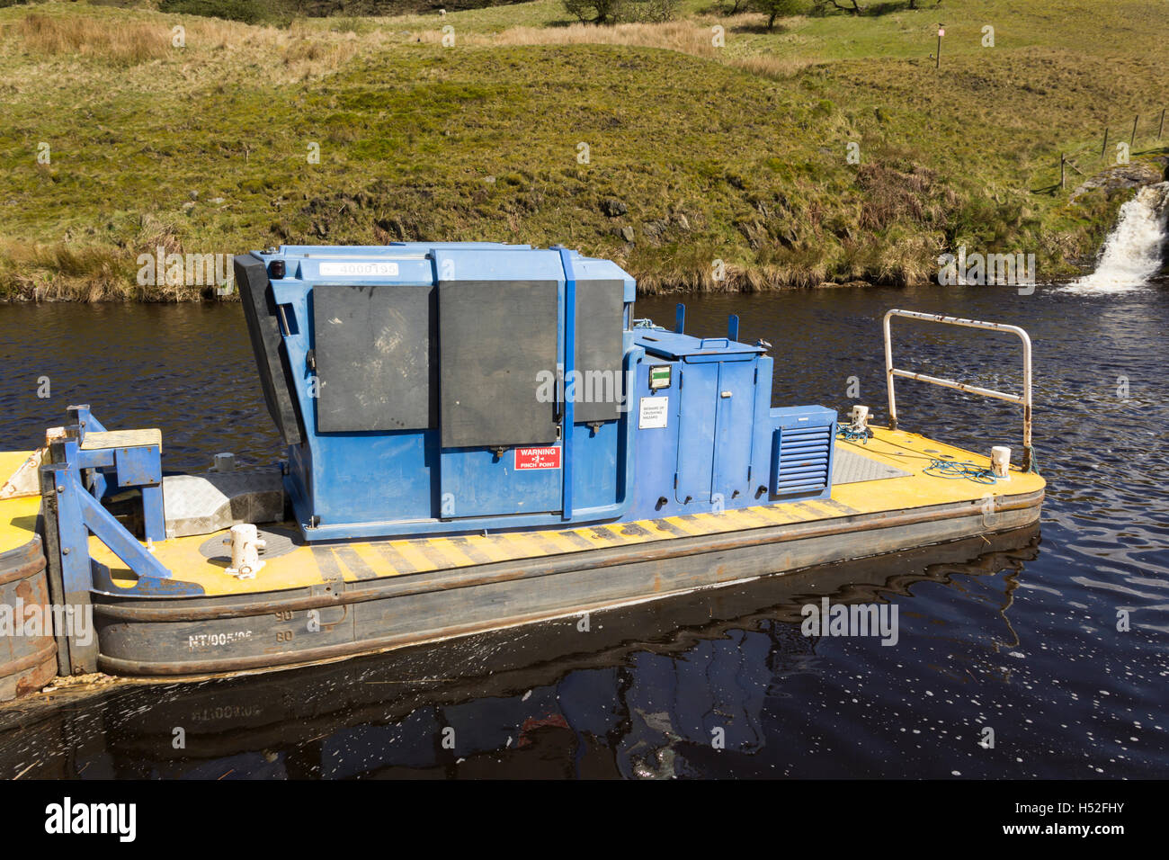 Canal maintenance boat moored on the Rochdale canal in the village of Walsden near the