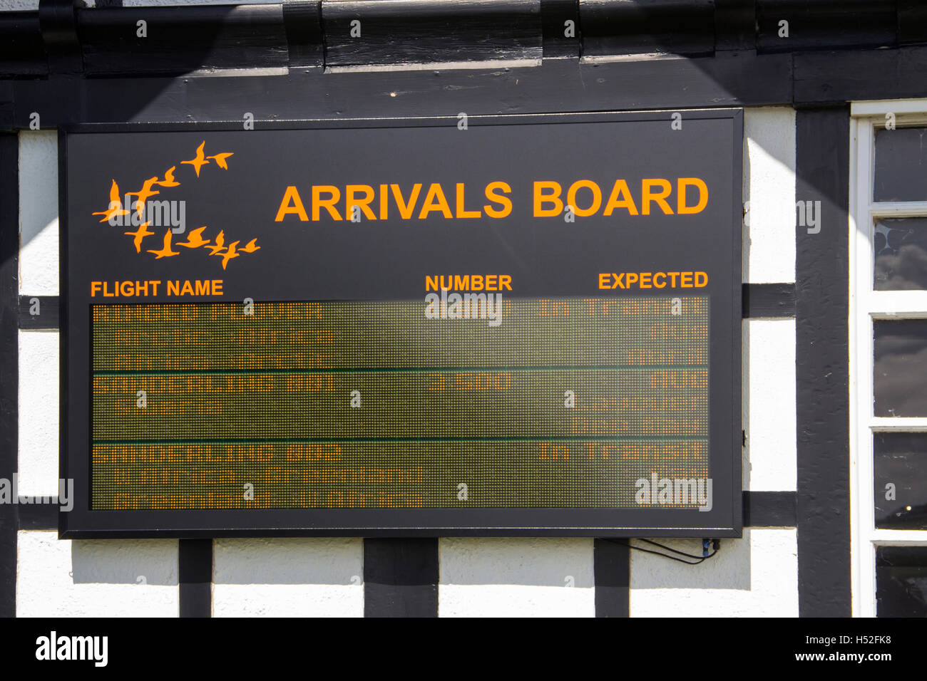 Arrivals board, giving migratory bird information, on the exterior of the RSPB Discovery Centre at Fairhaven Lake, Lytham. Stock Photo