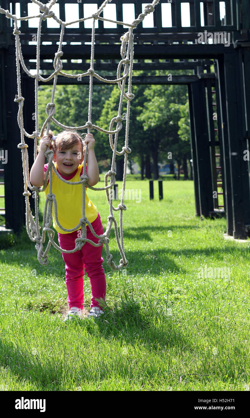 happy little girl playing on park playground Stock Photo - Alamy