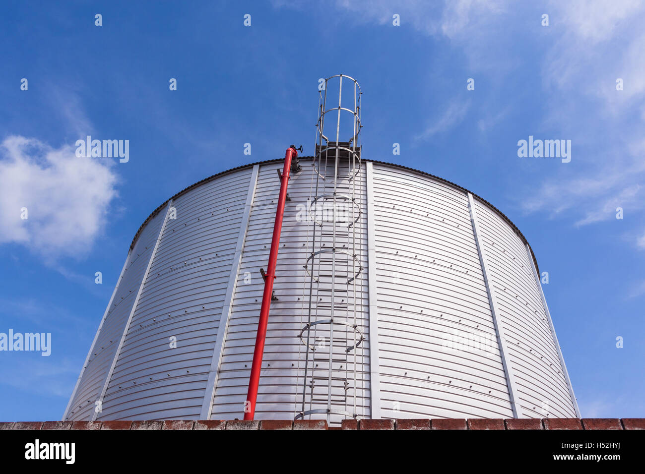 Industrial Tank for storage liquid water chemicals for factory closeup blue sky. Stock Photo