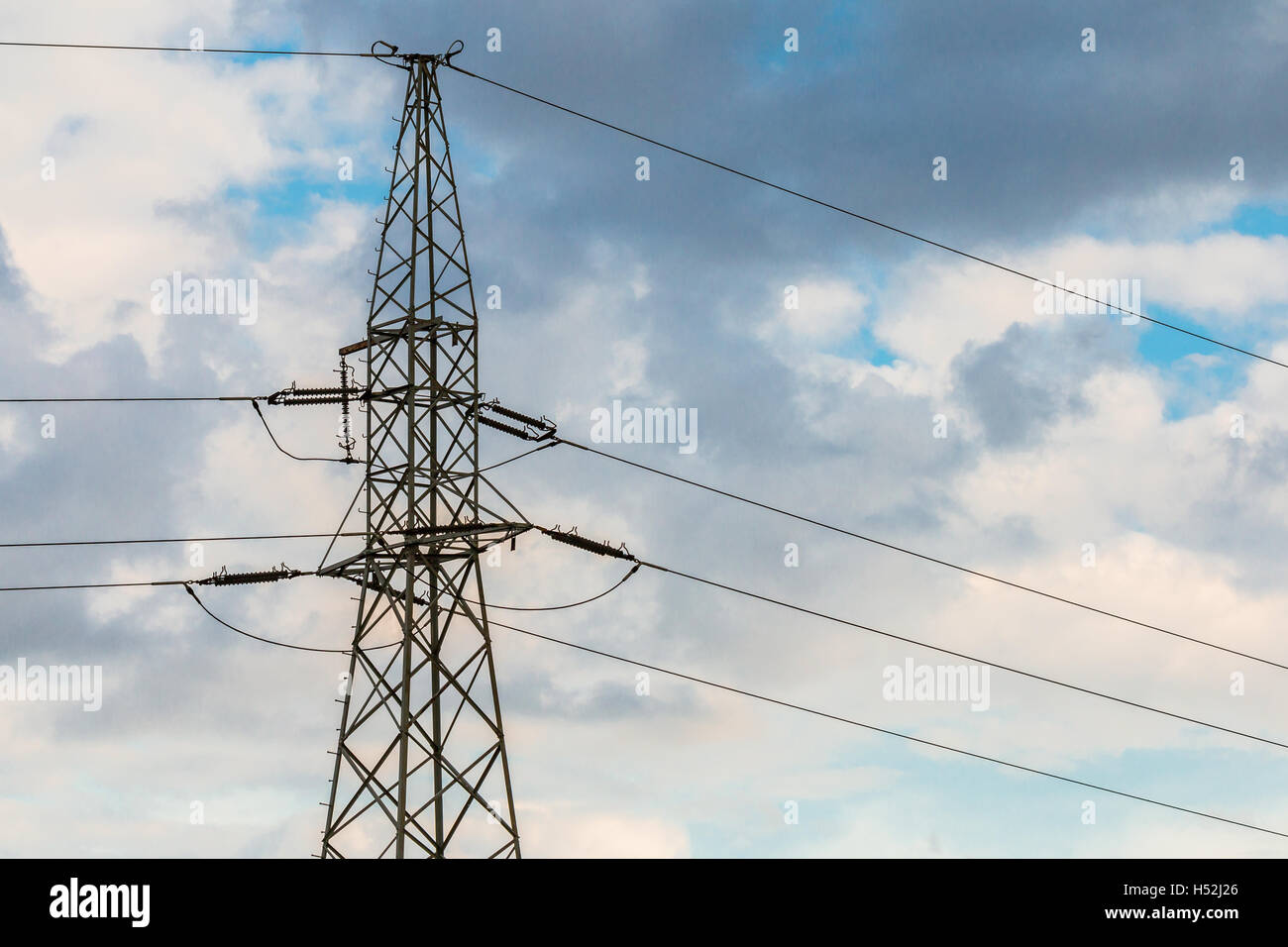 Power lines against cloudy sky Stock Photo - Alamy